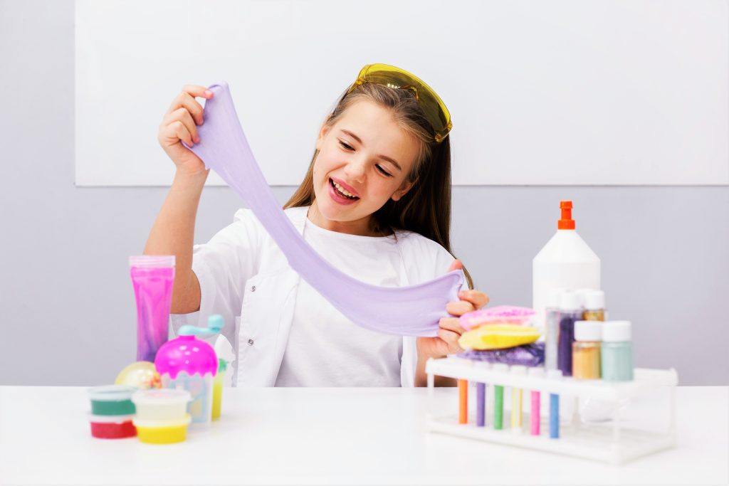 Girl playing with toy slime